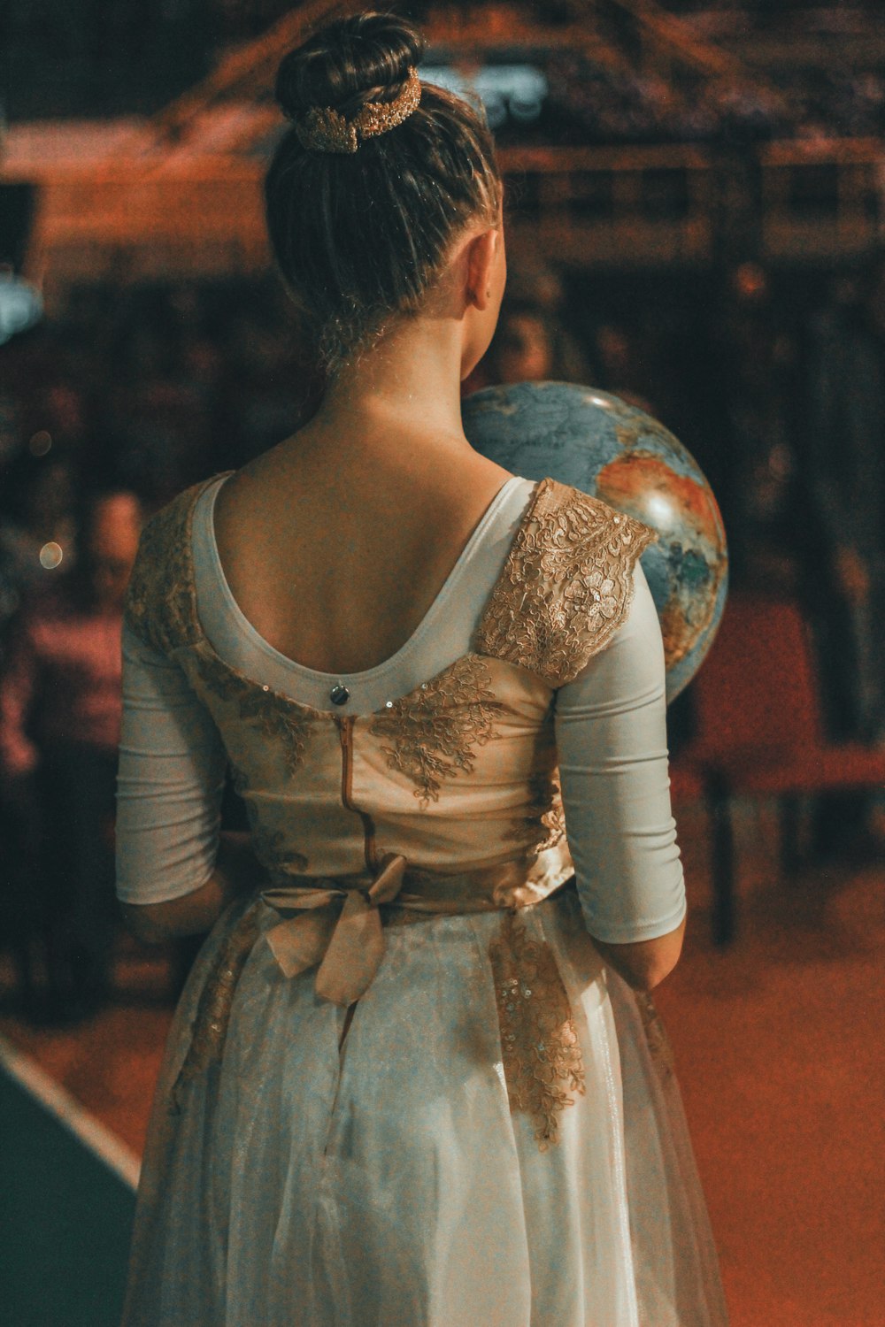 woman holding desk globe