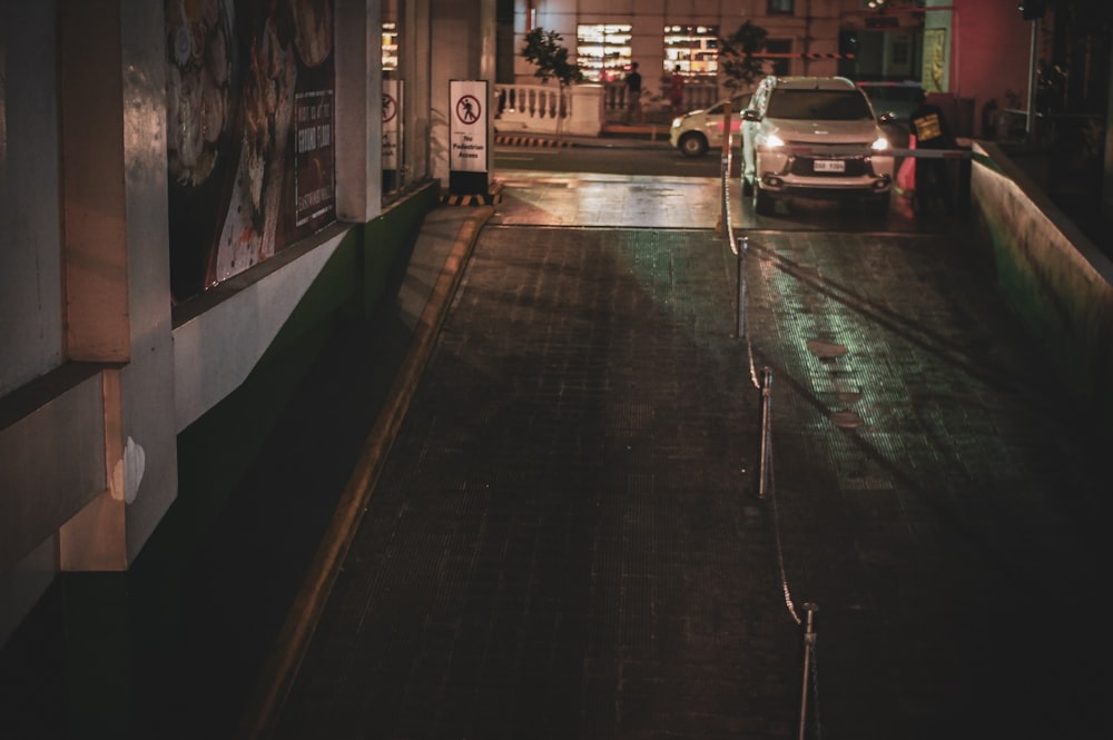 car on ramp near buildings during night