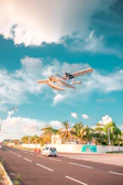 Private small airplane flying over lush green Caribbean islands with crystal clear sea