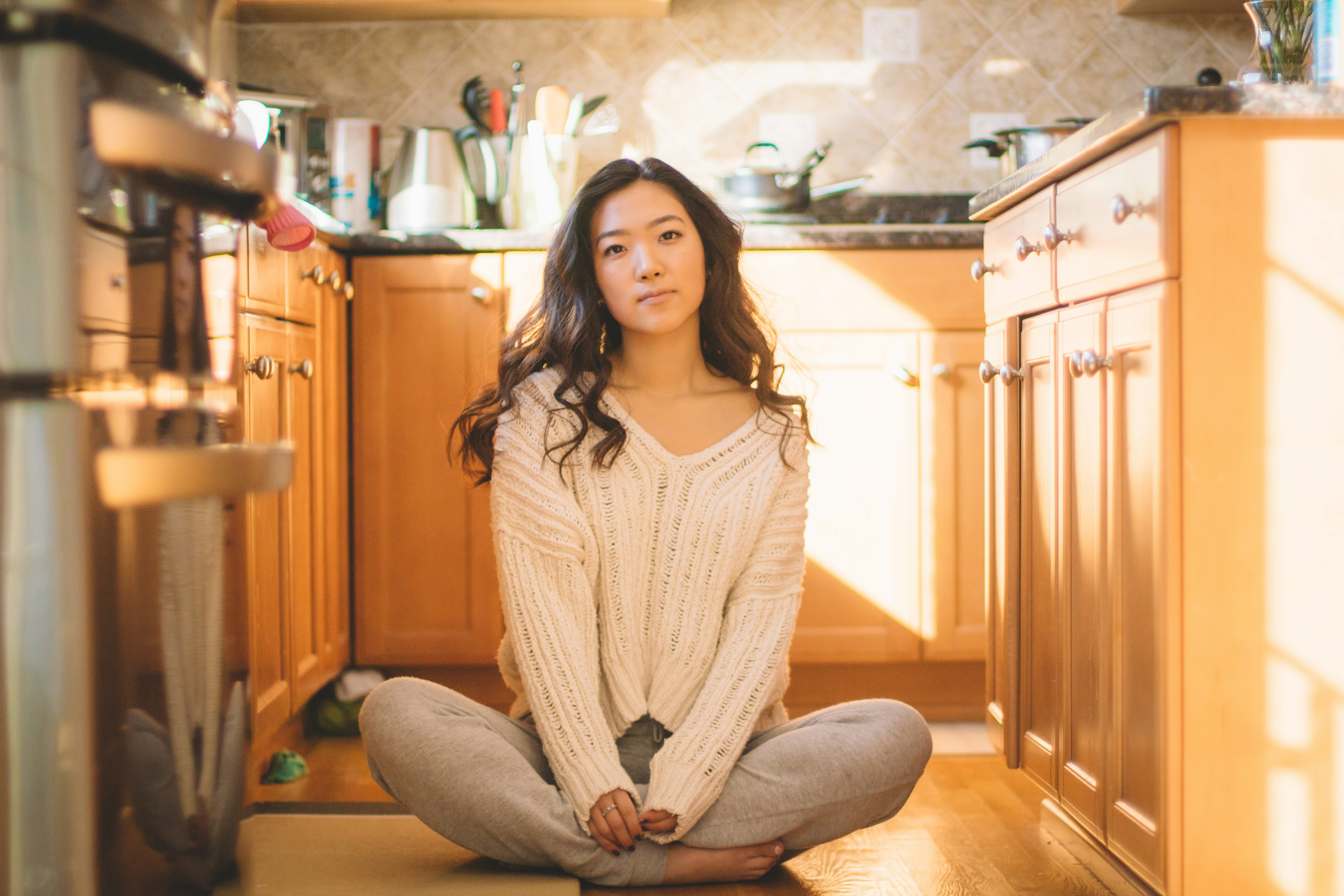 Woman meditating in kitchen