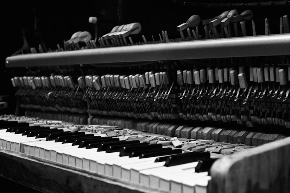 greyscale photo of piano