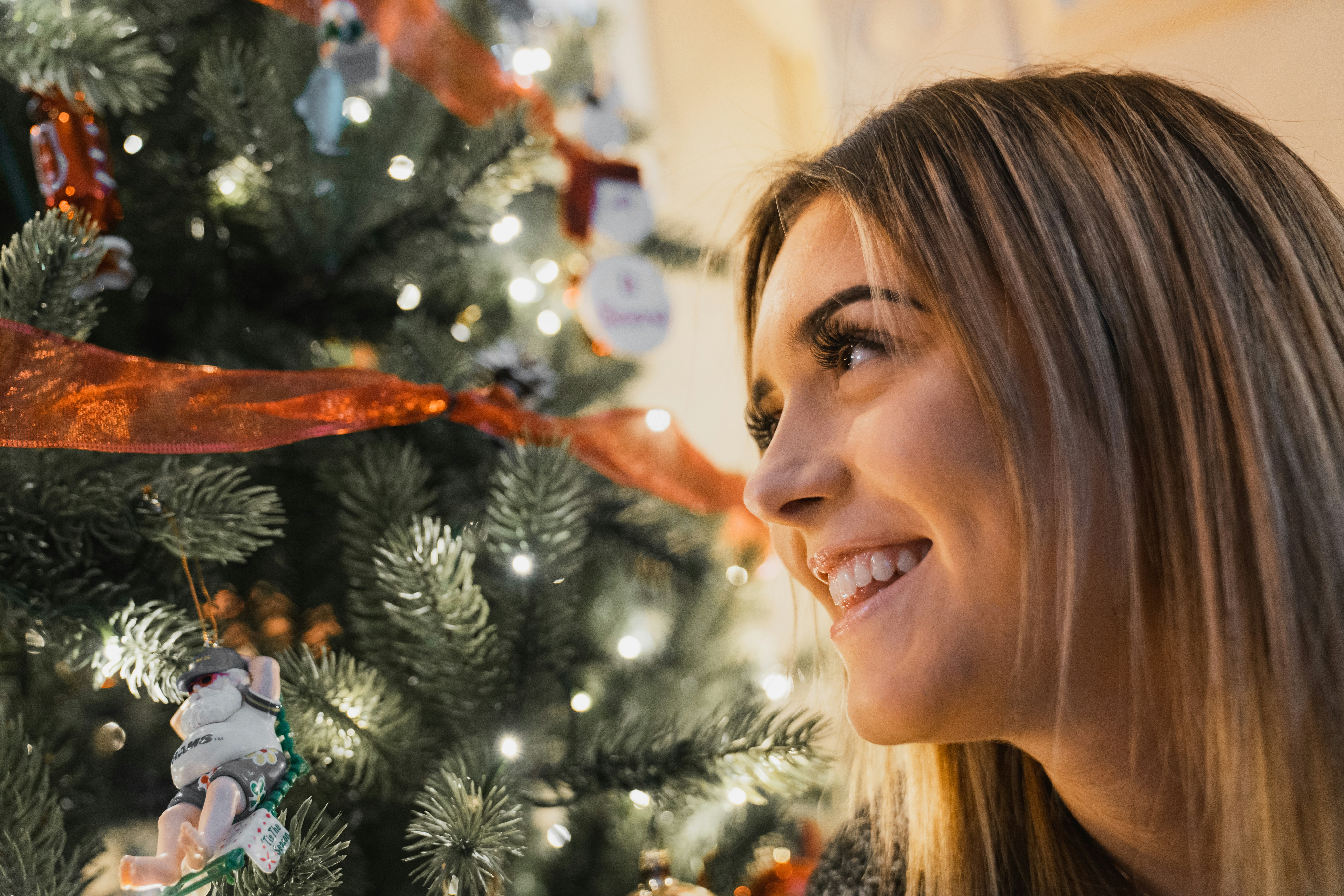 smiling woman near green Christmas tree