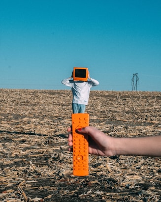 person wearing TV helmet with remote