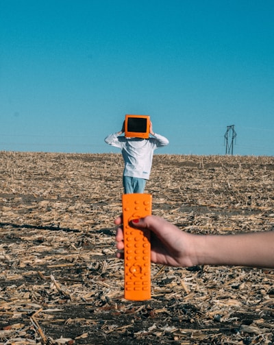 person wearing TV helmet with remote