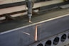 Amada CNC turret punch press working on a metal sheet.