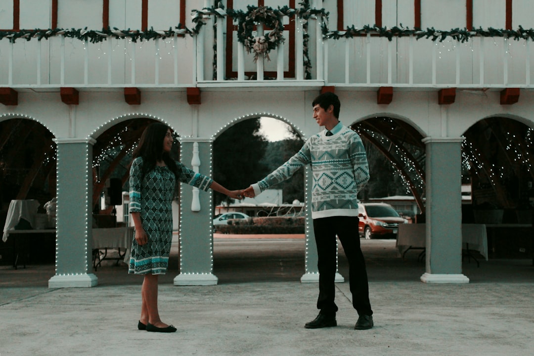 man and woman standing while holding hands on pathway near road, Love Mexican Vol IV
