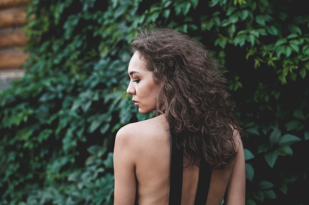 woman near green leaves