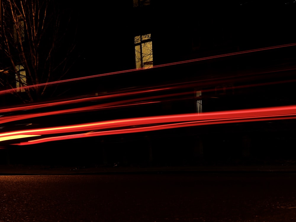 time lapse photography of vehicle passing by the street