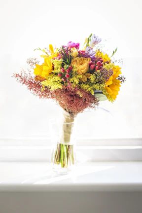 Colorful mixed bouquet featuring birthday flowers in a rustic basket