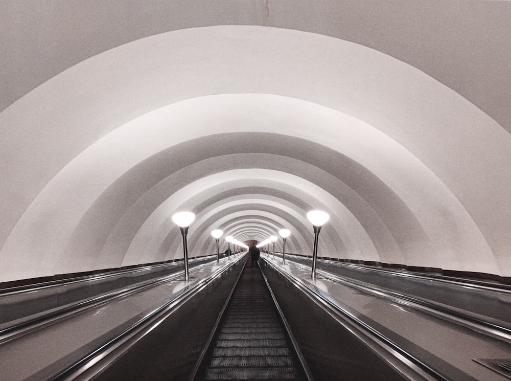 grayscale photography of an escalator
