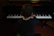 Young boy playing piano with a joyful expression in a colorful classroom.