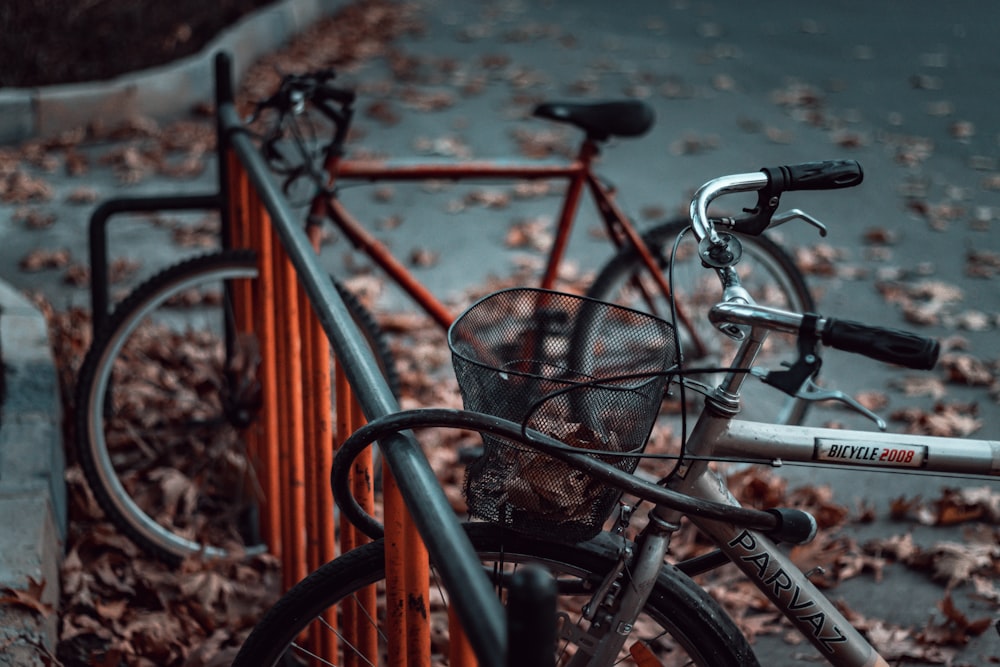 two gray and red bikes parking on bike rack