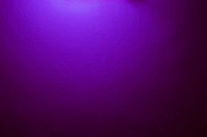 a purple wall with a clock on it