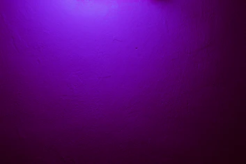 a purple wall with a clock on it