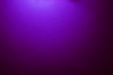 a purple wall with a clock on it