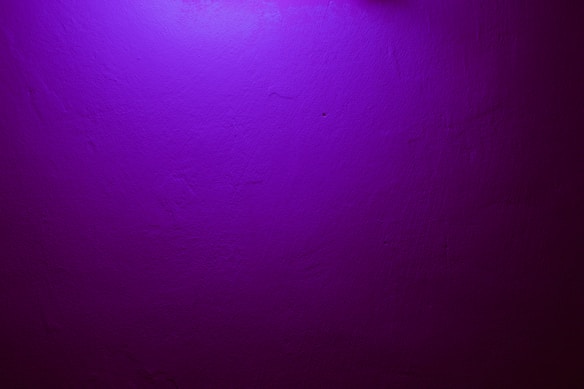 a purple wall with a clock on it