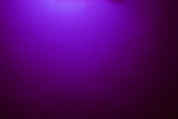 a purple wall with a clock on it