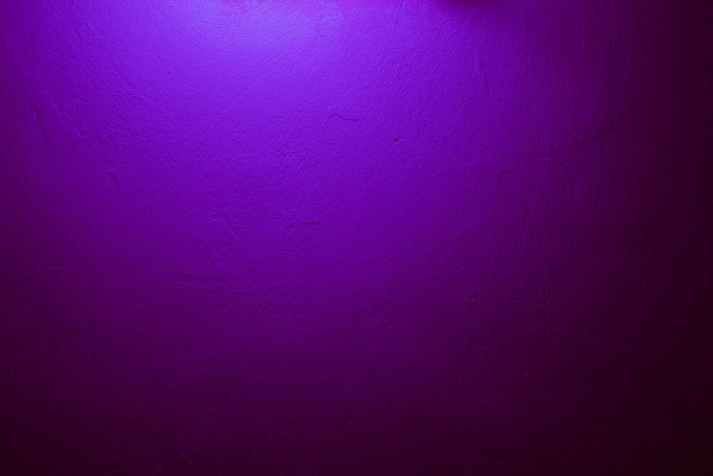 a purple wall with a clock on it