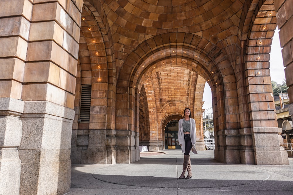 view photography woman standing under dome building during daytime