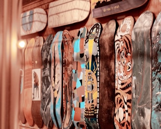 assorted-color skateboard decks displayed on wall