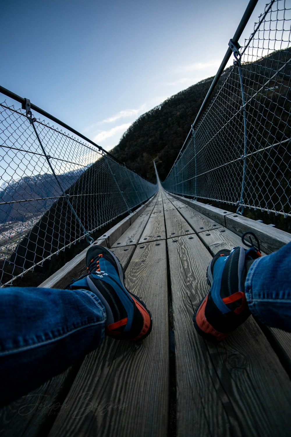 person sitting on bridge during day