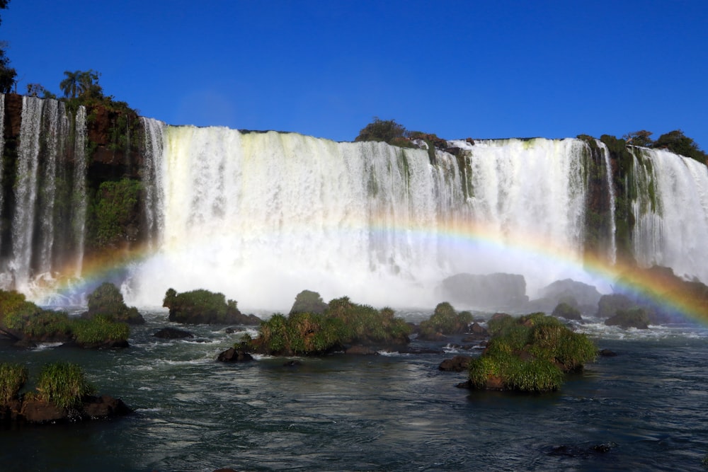 time-lapse photography of a rainbow over a flowing waterfall