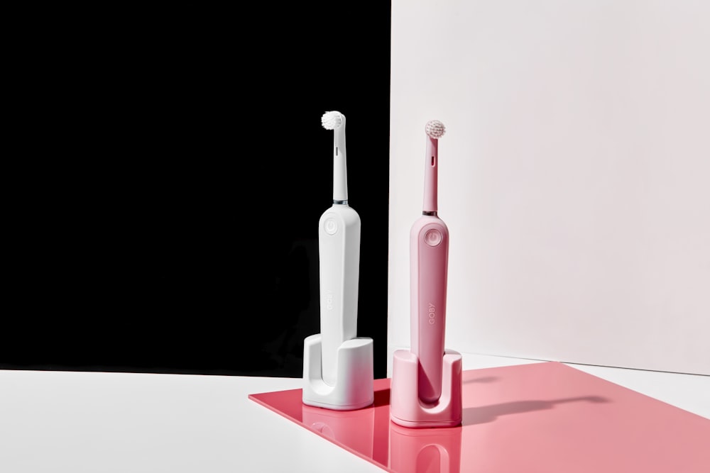 two electronic toothbrushes