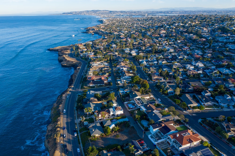 an aerial view of a city next to the ocean