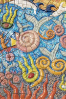 Artistic mosaic tile mural featuring ocean-inspired colors, installed on a Melbourne café wall.