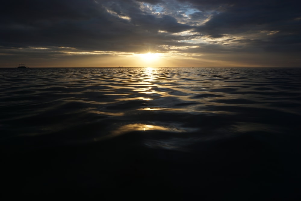 a large body of water under a cloudy sky