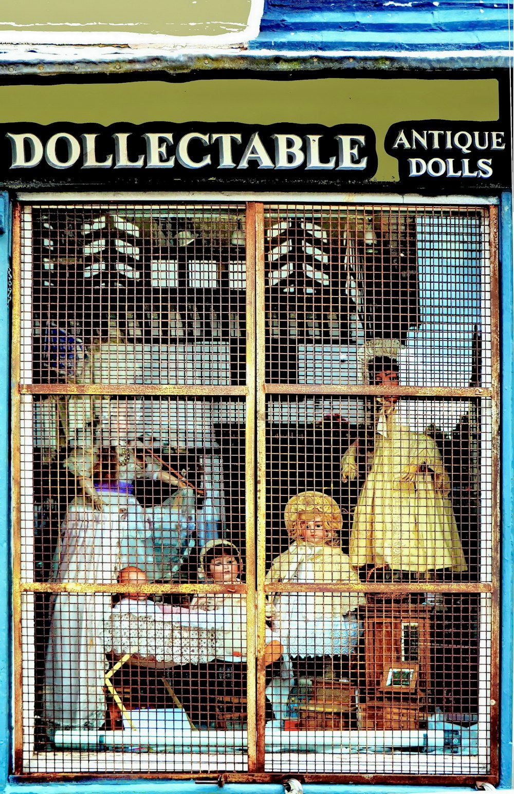 a group of dolls are in a caged area