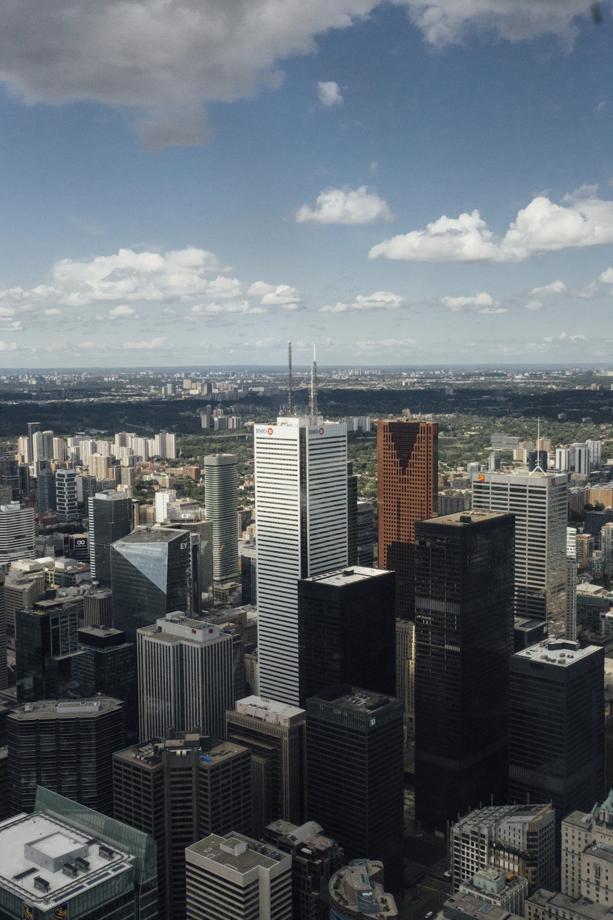 Wide-angle upward view of high-rise city skyscrapers against a cloudy sky, the kind of expansive architectural frame an ultra-wide lens makes possible