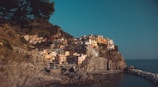Vibrant coastal village of Cinque Terre with colorful houses stacked on cliffs.