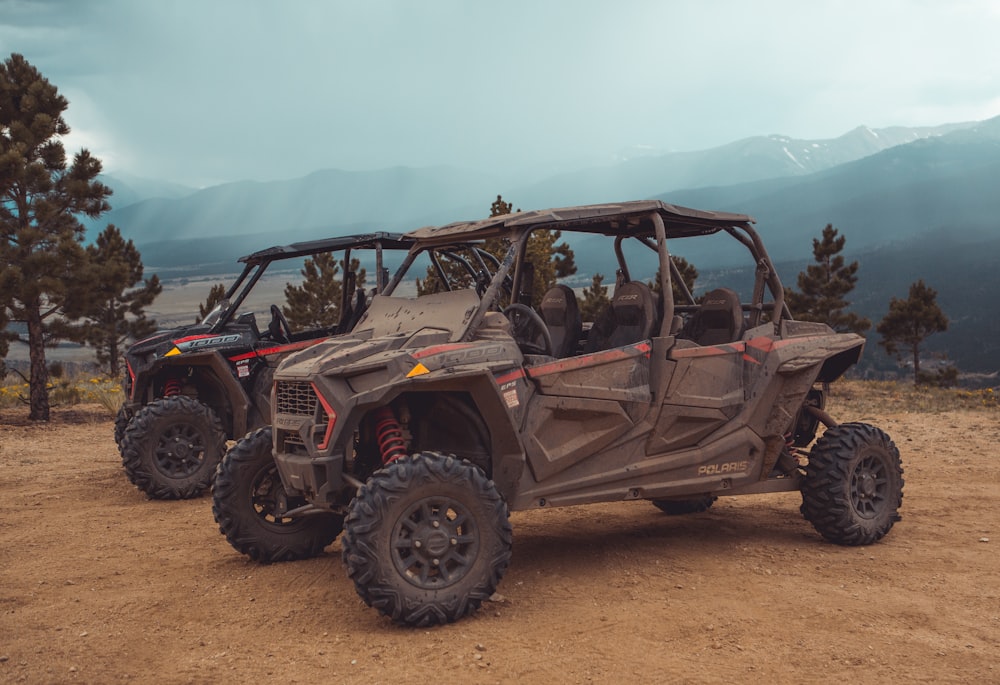 two brown utility task vehicles on brown field