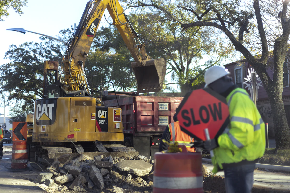 Road crew performing municipal street earthwork in Texas