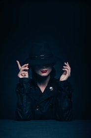 woman in black coat and hat