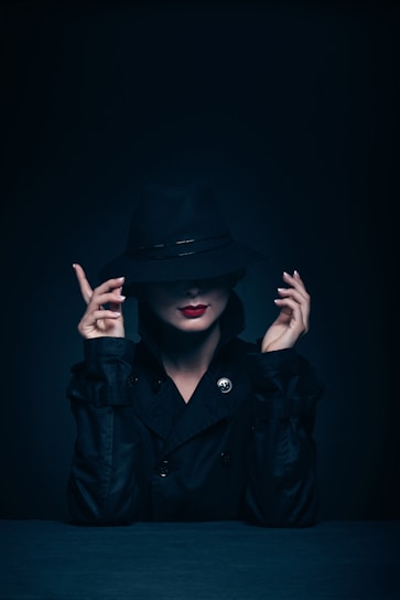woman in black coat and hat