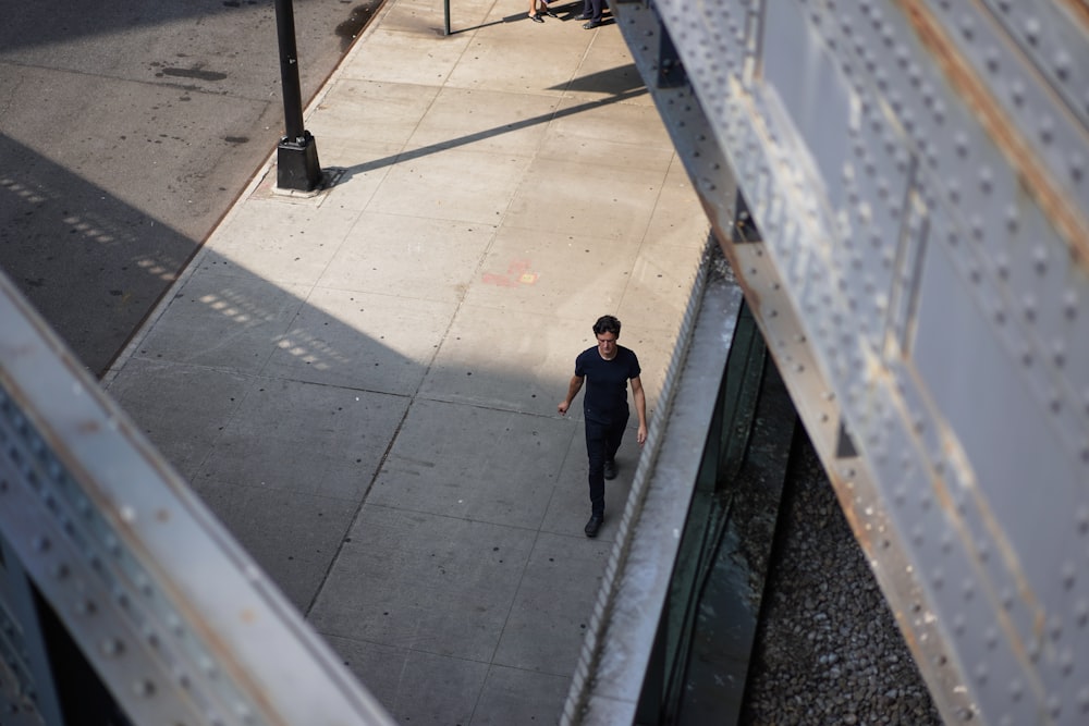 man walking on sidewalk