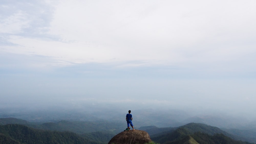 person standing on rock during daytime