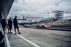 red coupe on road during daytime