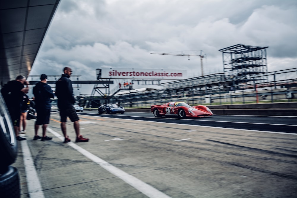 red coupe on road during daytime