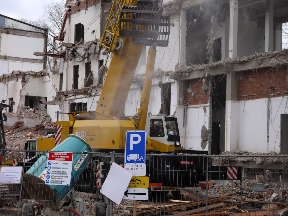 yellow heavy equipment beside building