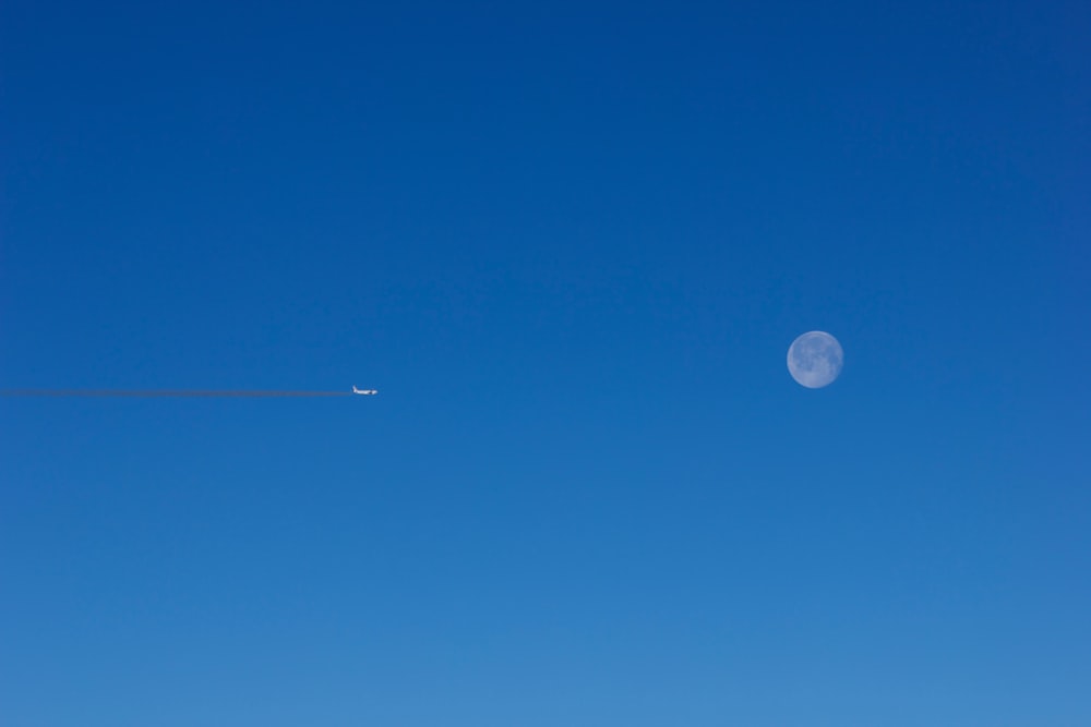 plane at flight overlooking full moon