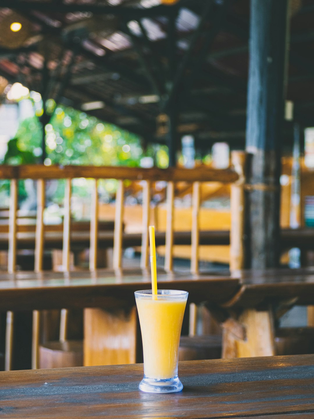 yellow liquid filled drinking glass