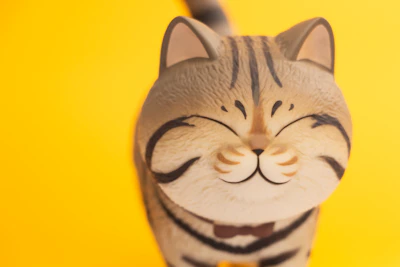 Close-up of a happy cat with a playful bow tie, showcasing detailed stitching.