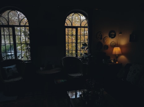 A warm, sunlit kitchen corner with autumn leaves scattered on the windowsill.