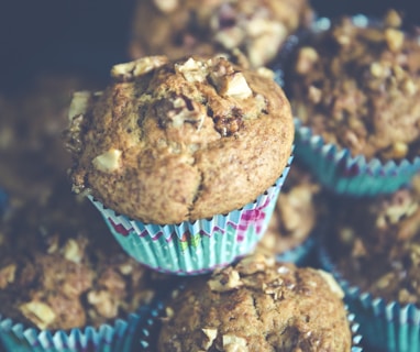 selective focus photo of pile of muffins