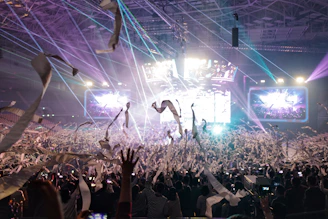 A vibrant event scene with megastar staff engaging a lively crowd.