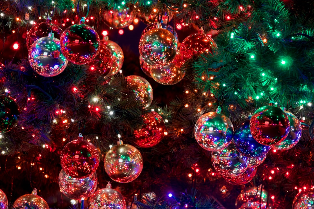 baubles on Christmas tree with turned-on lights, Christmas