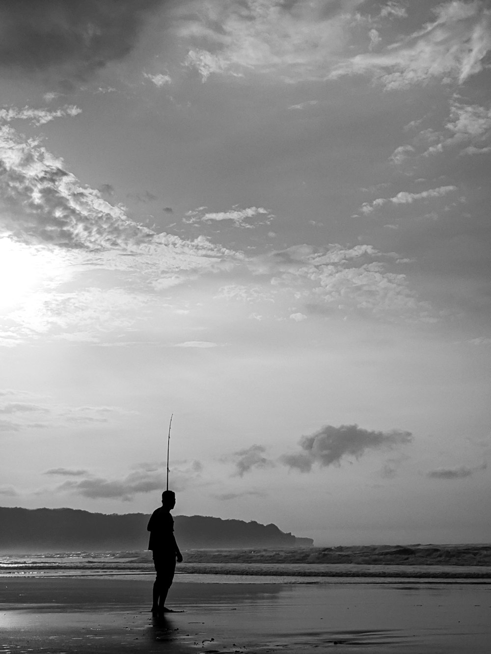 grayscale photography of man on seashore